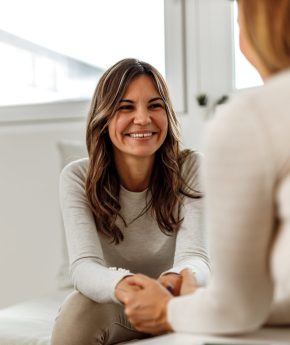 Smiling woman, talking to psychologist, feeling positive.